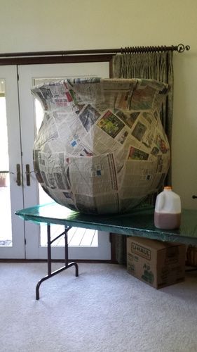 See photo:We are building a cauldron (the milk gallon is for scale).  It has the cardboard frame, shrink wrapped, and mache' to form it.  Which brings us to the monster mud part (this weekend).The question is...  How many layers of MM and cheesecloth do you think this beast will need to be solid enough to play with?  We don't intend it to actually hold water or anything daft like that, but we would like to keep it around for several years of cauldron witching business.We w Diy Paper Mache Halloween Decorations, Paper Mache Witch Cauldron, Paper Mache Cauldron, Halloween Cardboard Decorations, Cardboard Halloween Decorations, Paper Mache Halloween Decorations, Cardboard Halloween Decorations Diy, Paper Mache Halloween, Halloween Paper Mache