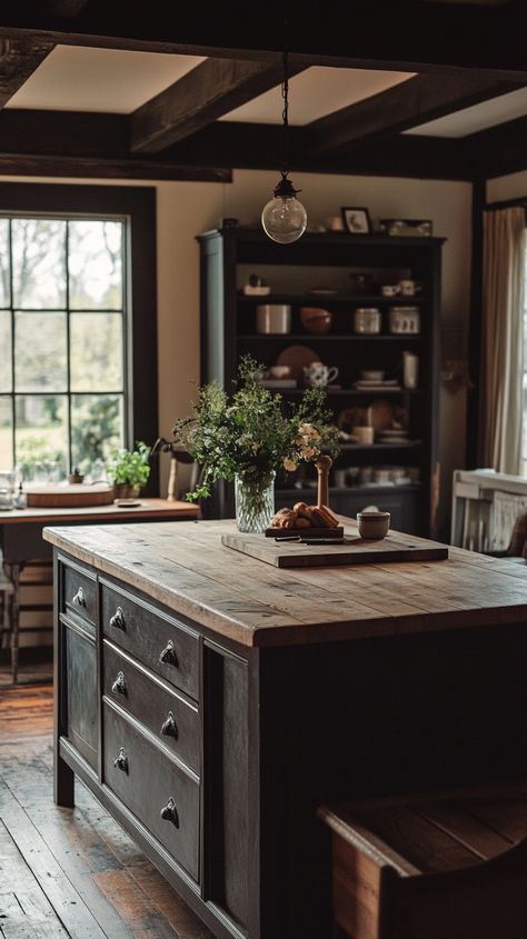 Rustic kitchen island with dark wood cabinets and light wooden top, set in a bright, open-concept home with vintage decor. Vintage Kitchen Islands, Kitchen Island Dark Wood, Sinks In Kitchen Island, Bakers Table Kitchen Island, Kitchen Island Cottage, Craftsman Kitchen Island, Old Rustic Kitchen, Rustic Industrial Kitchen Design, Dark Wood Island