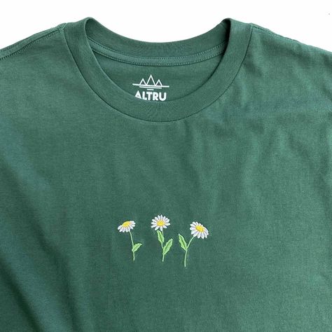 100% Cotton soft hand feel with regular fit 3 small Daisies embroidery on front chest Forest Green solid color shirt with embroidery Short sleeve tee. Rib collar. Neck and shoulder tape Style Code: ALT5187 Simple Shirt Embroidery, Lilypad Embroidery, Hand Embroidery Hoodie, Embroidery Designs Shirt, Embroidery Designs Tshirt, Embroidery Shirt Ideas, Hat Embroidery Ideas, Embroidery Tshirt Ideas, Embroidered Tshirts