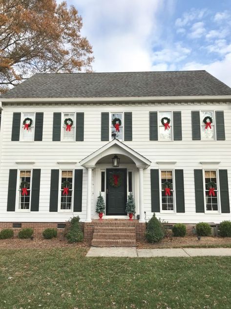 Black & White Colonial Christmas House Colonial Home Christmas Decor Outdoor, Colonial Christmas Exterior, Large Porch Christmas Decor, Houses With Christmas Wreaths On Windows Outside, Colonial Christmas Decorating Outdoor, Christmas Colonial House Exterior, Christmas Lights Colonial House Exterior, Classic Christmas House Exterior, Colonial House Christmas