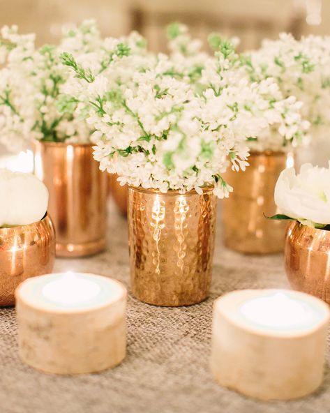 Play with contrast like using the color combination of copper and birch with added texture that gives a tablescape. Here, white blooms peak from mercury metallic vases—a glamorous contrast to the small birch votives nearby. #winterbridalshower #bridalshower #bridalshowerideas #bridalshowerdecor | Martha Stewart Weddings - 19 Tips for Throwing the Ultimate Winter Bridal Shower Winter Bridal Shower Centerpieces Diy, Winter Bridal Shower Ideas, Winter Bridal Shower Decorations, Winter Table Decorations, Wedding Copper, Centerpiece Vases, Simple Bridal Shower, Winter Bridal Showers, Wedding Brunch