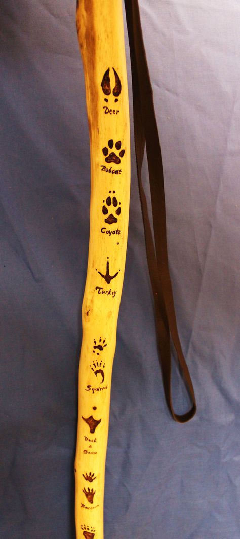 Hiking stick with animal track, just the pic but like the idea so when you are hiking you can identify the animal Walking Stick Wood Burning Designs, Leaf Stencils, Hiking Staff, Hand Carved Walking Sticks, Wooden Canes, Woodburning Projects, Dremel Wood Carving, Wooden Walking Sticks, Walking Sticks And Canes