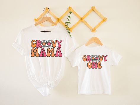 "This \"groovy one\" tee would make the perfect 1st birthday outfit for a \"groovy 1\" party!! Looking for the matching \"groovy mama\" tee? Check out my shop or click the link to take you right to it- https://www.etsy.com/listing/1222858747 *HOW TO ORDER* 1. Look through photos at the different colors and the sizing chart (all shirts & sweatshirts are unisex!) 2. Select your size and color from the drop down menus. 3. Choose the quantity you want in that size and color. 4. If applicable, add yo 2 Groovy, Groovy Birthday Party, Third Birthday Girl, Hippie Birthday Party, Groovy Tees, Groovy Mama, Groovy One, Girls 3rd Birthday, Groovy Shirt