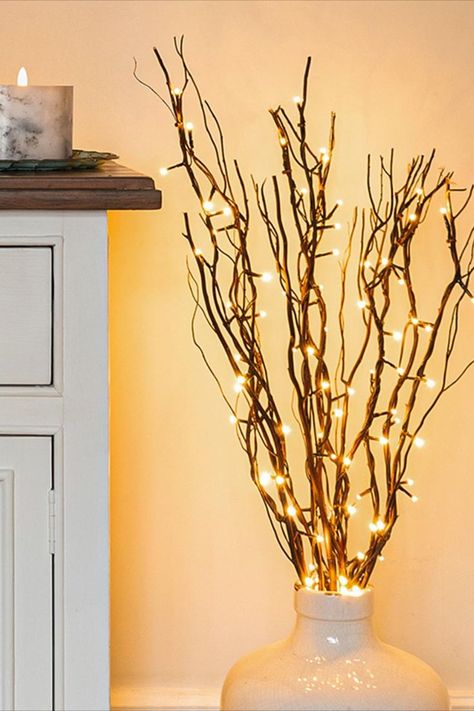 Create a warm and inviting ambiance in your living room with these enchanting indoor lighting ideas! From soft candles that twinkle like stars to elegant fairy lights that cast a gentle glow, discover the perfect ways to infuse coziness into your space ✨ Fall Garland Diy, Lighted Tree Branches, Living Room Candles, Cosy Decor, Vase With Branches, Twig Lights, Tree Branch Decor, Fairy Lights Decor, Snow Effect