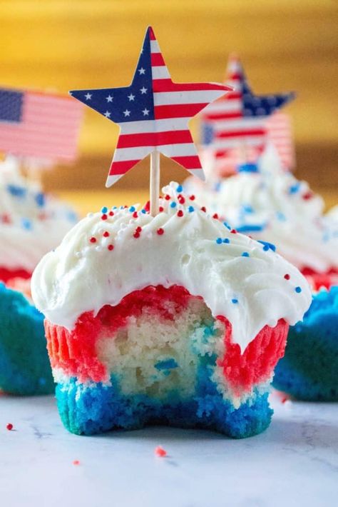 Red White and Blue Patriotic Cupcakes are the perfect Fourth of July Cupcakes to show off your American pride. Made using a box cake mix and topped off with homemade buttercream frosting, these red, white and blue layered cupcakes will be the star of every Fourth of July dessert table. | A Wicked Whisk #redwhitebluecupcakes #redwhitebluedesserts #redwhitebluedesserts4thofjuly #redwhitebluedessertsmemorialday #redwhitebluecupcakes4thofjuly #redwhitebluecupcakesamericanflag Layered Cupcakes, 4th Desserts, Fourth Of July Dessert, Patriotic Snacks, Patriotic Cupcakes, Lemon Cupcake, Homemade Buttercream, Honey Garlic Pork Chops, Passover Desserts