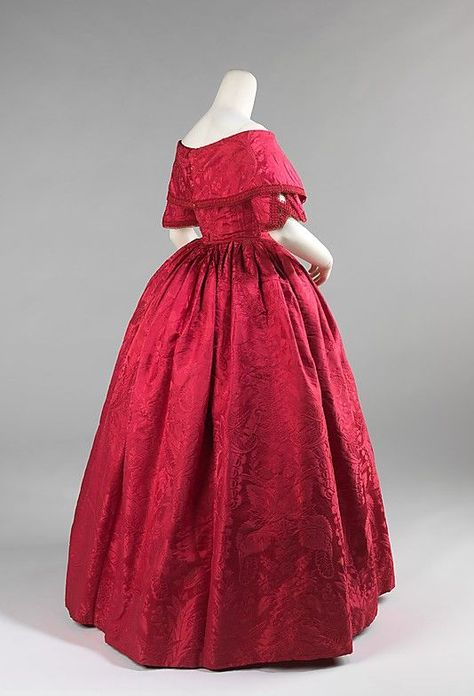 ~ca. 1842. This is a striking example of how 18th-century fabric was treasured. The textile was probably originally a 1740s dress which was taken apart and then reconfigured into this fashionable dress in the early 1840s. The elongated waist and V-shaped bodice front emphasize the bust and wide shoulders and were key features of the dresses of the period~: 1840s Fashion, Antique Dresses, Victorian Times, Cranberry Color, 19th Century Fashion, Old Dresses, Century Clothing, Victorian Clothing, Costume Collection