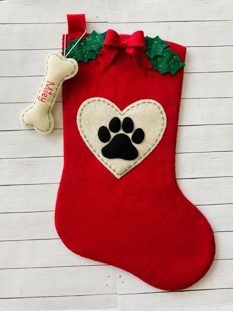 **THIS IS A PDF PATTERN DOWNLOAD. ** No finished product will be shipped.  Add a special touch to your home this holiday season with this beautiful felt stocking!  With your purchase, you will receive the PDF pattern download for this paw print felt pet stocking and the fish and bone shaped name tag ornaments.  This is a full size stocking, measuring roughly 18" diagonally. It is designed to be a fully functioning stocking that can be used by your family for years. This is a fantastic handmade g Christmas Stockings Sewing, Dog Clothes Patterns Sewing, Cat Christmas Stocking, Hanging Christmas Stockings, Christmas Gift Handmade, Dog Christmas Stocking, Stocking Designs, Pet Stockings, Dog Stocking