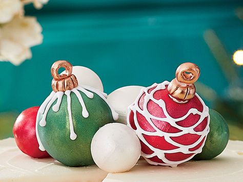 Cake Ball Ornaments Recipe | What better way to top a Southern Living white cake than with these festive cake balls. These charming (and edible) ornaments can be colored however you wish with melted candy coating disks. You’ll need about 1 1/2 pounds of disks to cover 20 cake balls. Add Luster Dust in the ornaments’ colors for a sparkly finish, if desired. Top this year's Snowy Vanilla Cake with these ornaments we can't guarantee they will make it to dessert. Edible Ornaments, 20 Cake, Melted Candy, Ornament Cake, Edible Luster Dust, Soda Cake, Cake Ball, Crumble Cake, Vanilla Cake Mixes