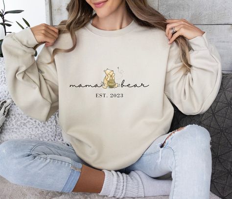 "Mama Bear Sweatshirt, Winnie Pooh Mama Sweatshirt, comfort color shirt, Personalized Gift New Mom, gift for mom, mother, mom sweatshirt. Valentines Day Shirt, Valentines Sweater, Heart Love Tee, Cute Retro Valentines, Be Mine Valentine, Gift For Women, Gift For Mom, Gift For Girlfriend, Cute Sweatshirt, Valentine's Shirt A thoughtful gift for a friend, family member, or loved one, or a treat just for you. Keep them close to your heart and wear your love on your sleeve. Your loved one will without a doubt treasure this thoughtful and reasonably priced gift. HOW TO ORDER Step 1: Select your shirt - Style/Color (Ex: Sweatshirt White) Step 2: Select your shirt - Size (Ex: S) Step 3: Add any requests in the \"Add your personalization\" box (if requested). Step 4: Select the quantity. CARE INST Mama Bear Hoodie, Mama Bear Sweatshirt, Pregnancy Outfit, Anime Cake, Mama Crewneck, Pooh Baby, Mama Gifts, Bear Shirt, Mama Sweatshirt