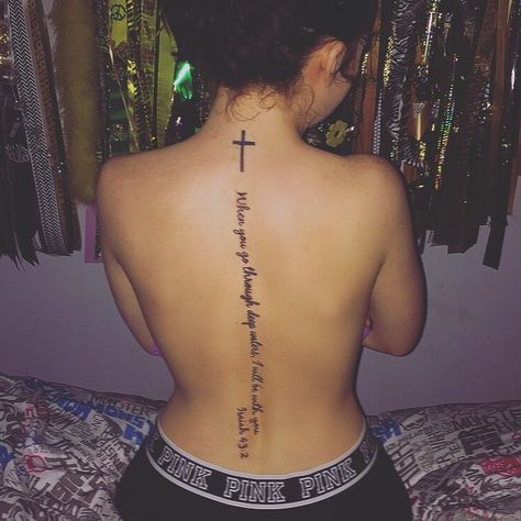 "When you go through deep waters, I will be with you. When you go through rivers of difficulty, you will not drown. When you walk through the fire of oppression, you will not be burned up; the flames will not consume you." Isaiah 43:2 Spine Tattoos For Women With Cross, Biblical Back Tattoos For Women, Biblical Spine Tattoos For Women, Spin Tattoo Ideas, Spine Tattoos For Women Bible Verses, Meaningful Spine Tattoos For Women, Spin Tattoos For Women, Spin Tattoos, Spin Tattoo