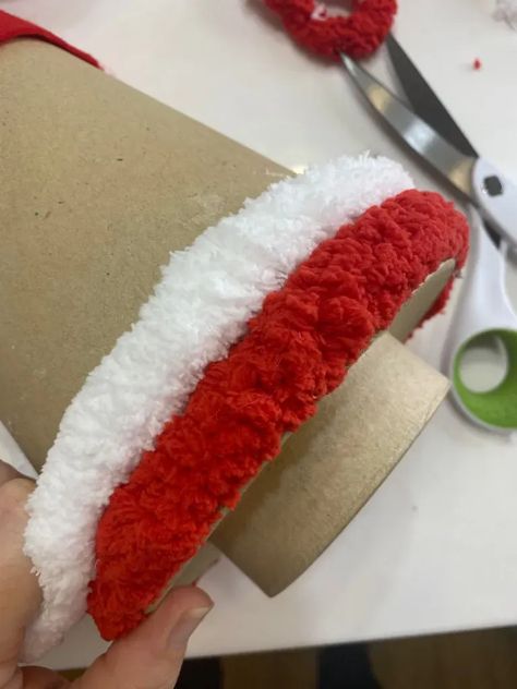 adding red and white chunky yarn to a cardboard cone to make a candy cane tree Candy Cane Wreath With Yarn, Chunky Yarn Craft Ideas, Crafts With Chunky Yarn, Chunky Yarn Trees Christmas Diy, Yarn Wrapped Christmas Tree Diy, Candy Cane Gnome, Candy Cane Yarn Wreath, Decorating With Candy Canes, Chunky Yarn Trees