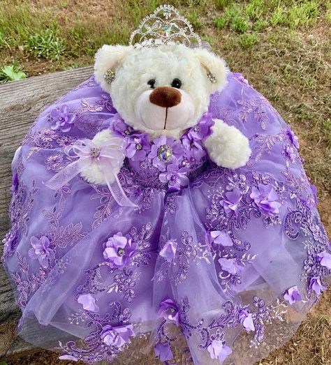 Ideal bear for your quinceanera party, it measures approximately 17" Each dress of our bears is custom designed matching the tone to the color of your quinceanera dress. It is worth mentioning that the tone of the fabric may vary, as well as the accessories (crown, earrings or necklace) If you need a more personalized bear or the same as your dress, it can also be made. Our specialty is satisfying our clients. You can contact us if you require a custom design. Contact: 817-443-7252 FB: Norma Vazquez Fashion Designer https://www.facebook.com/profile.php?id=100077462744454 Quince Doll Purple, Light Purple Quinceanera Dresses Butterfly, Royal Purple Quinceanera Dresses, Rapunzel Quinceanera Dress, Purple Quinceanera Dresses Butterfly, Enchanted Forest Theme Quinceanera Dress, Repunzel Quince Theme, Quincera Dress, Light Purple Quinceanera Theme