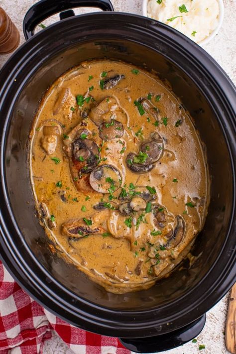 These Slow Cooker Pork Chops with Mushroom Gravy are comfort food at its finest. They’re juicy, creamy, flavorful, and super easy to make. Slow Cook Pork Chops, Thick Pork Chop Recipe, Pork Chops With Mushroom Gravy, Mushroom Slow Cooker, Pork Loin Crock Pot Recipes, Slow Cooker Pork Chops Recipes, Slow Cooker Pork Loin, Slow Cooker Pork Roast, Pot Roast Crock Pot Recipes