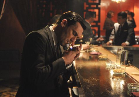 Don Draper sitting at the bar lighting a cig. Mad Men Don, Mad Men Don Draper, The Kings Of Summer, John Hamm, Man Bars, Vanessa Kirby, Don Draper, Jon Hamm, New Museum