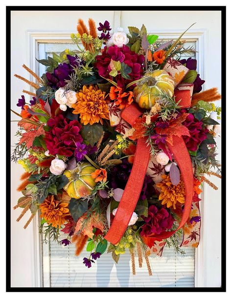 Colorful Autumn Door Wreath, Designer Fall Floral Wreath SUGAR CREEK DECORATINGVISIT MY SHOP AT LINK BELOW https://www.etsy.com/shop/SugarCreekDecorating?ref=ss_profile&section_id=21043858 This is a gorgeous colorful fall door wreath that is perfect for the harvest season all the way through Thanksgiving. It has gorgeous deep purple peonies, maroon hydrangeas, gold dahlias, cream mini ranunculus, orange cosmos and purple mini cosmos and a lot of other beautiful fall foliage and fillers and grasses, a lovely double bow and two pretty little pumpkins nestled within. It measures @ 28"L x 24"W x 8"D and is made on a 14" grapevine wreath. Great for the fall autumn season. All of my floral arrangements are unique and one of a kind with much attention to detail. For 20 years my love for flowers a Fall Hydrangea, Purple Peonies, Fall Thanksgiving Wreaths, Peonies Wreath, Door Wreaths Fall, Fall Door, Thanksgiving Wreaths, Dahlia Flower, Fall Decor Diy