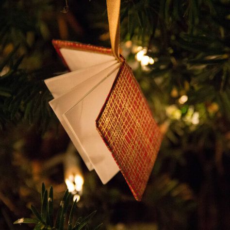 This red and gold miniature book on a satin ribbon is included in a round up of handmade paper tree ornaments Paper Tree Ornaments, Diy Tiny Books, Book Ornaments, Book Ornament, Book Christmas Tree, Paper Christmas Ornaments, Rustic Ornaments, Miniature Book, Vbs Crafts