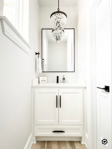 White and black powder room #chandelier #powderroomideas #guestbathroomideas #bathroomdecor #bathroomideas