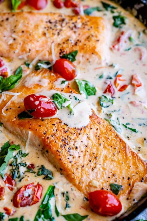 Creamy Tuscan Salmon (30 Minute Dinner!) from The Food Charlatan. This Creamy Tuscan Salmon recipe is totally restaurant quality, but super easy to make! Perfectly pan-seared salmon, drowning in a creamy parmesan sauce with garlic, cherry tomatoes, spinach, and fresh basil. It's the perfect summer meal and is done in 30 minutes! #easy #recipe #summer #garden #salmon #tuscan #creamy #cherrytomato #basil #spinach #parmesan #tomato #30minutedinner #oneskillet #garlic #butter #garlicbutter #pasta Creamy Tuscan Salmon, Salmon Recipe Pan, Tuscan Salmon Recipe, Tuscan Salmon, Spinach Parmesan, Salmon Recipes Pan Seared, Salmon Spinach, The Food Charlatan, Creamy Parmesan Sauce