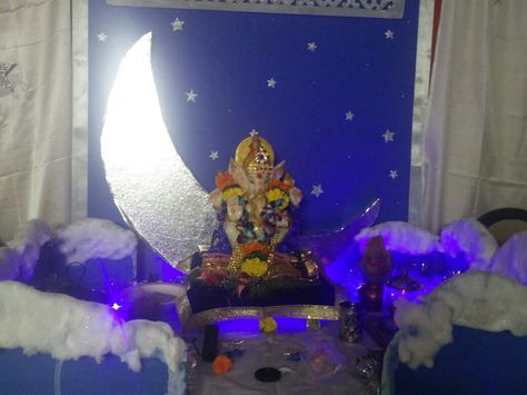 Backdrop made from ply,  curtains made from satin cloth,  moon made from thermocol and clouds on the table made from cardboard,  chart paper and cotton.  Sprinkled some glitter for the effect. Readymade stars stuck on the backdrop and curtains. Ganpati Backdrop, Chart Paper, Moon Made, Ganpati Decoration At Home, Ganapati Decoration, Dining Etiquette, Ganpati Decoration Design, Wedding Backdrop Decorations, Ganpati Decoration