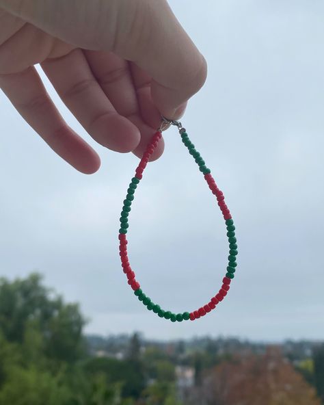 This super cute red and green bracelet is perfect to wear for the holiday season especially for the Christmas time!! - - dm me if you have any questions - (Christmas collection)❤️💚🤍 Christmas Gift Green Bracelet, Handmade Green Bracelets For Holiday, Green Christmas Gift Bracelets, Christmas Green Beaded Bracelets, Green Christmas Festive Bracelets, White Choker, Green Beaded Bracelets, Turtle Charm, Christmas Bracelet