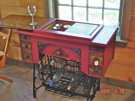 I love making wine carts out of treadle sewing machines. The wine rack was a steel milk crate. Sewing Machine Bar Cart, Crooked Furniture, Singer Sewing Machine Repurposed, Antique Sewing Machine Table, Sewing Table Repurpose, Upcycled Furniture Before And After, Making Wine, Sewing Machine Tables, Sewing Machine Cabinet