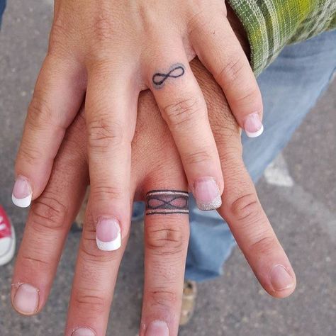 50 Lovely Wedding Ring Tattoos Couples Tats, Wedding Ring Finger Tattoos, Tattoo Rings, Ohm Tattoo, Marriage Tattoos, Tattoo Journal, Ring Tattoo Designs, Wedding Band Tattoo, Small Wave Tattoo