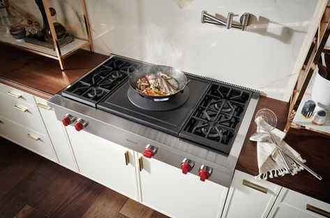 A new item in the Wolf lineup is our sealed burner rangetop, with a wok burner and 4 burners(48") or 2 burners(36"). It aptly handles the gamut of wok cooking techniques with equal precision, from searing highs of 35,000 Btu to simmering lows of 3,500 Btu.  Porcelain-coated cast-iron wok ring cradles a traditional round-bottom wok, offering extreme pan maneuverability and ability to angle the pan towards the cook for convenient access to contents. Wok Kitchen Design, Wok Stove, Glass Front Refrigerator, Kitchen Burner, Wok Kitchen, Wolf Oven, How To Clean Burners, Wok Burner, Stove Top Burners