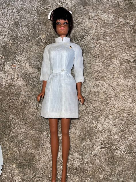 Julia Doll, original marked Mattel. She is an 11 1/2 inch tall, jointed doll. She was made for the TV character, Nurse Julie, starring Dianne Carroll. Nurse Julie is dressed in her original, white uniform that is in good condition. complete with nurses cap.  She is a beautiful African American Doll with light brown skin, Brown eyes, Short straight brown hair, Rooted eyelashes, Bendable Knees, Twist N Turn Waist. Green discoloration at ears on both sides of face. Please see pictures as it is part of the description.    Dress snaps in the back, complete with both snaps. Missing shoes. Does NOT come with case in background. Brown Skin Brown Eyes, Short Straight Brown Hair, Dianne Carroll, Nurse Julie, Straight Brown Hair, Side Of Face, Light Brown Skin, White Uniform, Tv Character