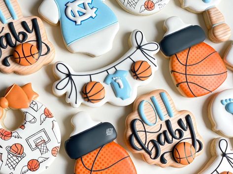 Ashley on Instagram: “A baby shower set fit for Tar Heels fans! UNC blue mixed with orange made for a fun color palette and I used a random illustration from one…” Basketball Theme Baby Shower, Random Illustration, Fun Color Palette, Jordan Baby Shower, Basketball Baby Shower, Sports Baby Shower Theme, Sports Baby Shower, Basketball Baby, Chocolate Babies