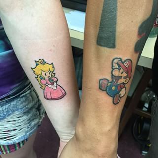 And this Princess Peach and Mario match made in NES heaven. | 23 Geeky Couple Tattoos That Are Beyond Perfect Peach Tattoo, Couple Tattoos Love, Couple Tattoos Unique Meaningful, Mario Tattoo, Small Couple Tattoos, Couple Matching Tattoo, Tattoos Infinity, Couple Tattoos Unique, Single Line Tattoo