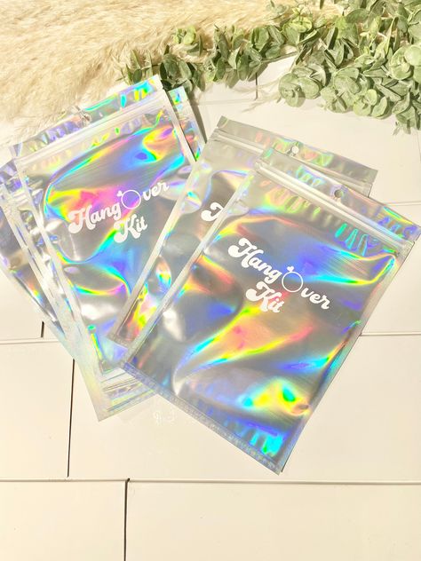 "Perfect 6\" x 9\" Holographic Resealable Bags - These holographic bags are made of quality metalized film, durable and shining, which provide you fantastic rainbow colors effect. The front side of the resealable bags for packaging is clear, so you could see what is inside. These large resealable bags are reusable and safe for your use. Holographic Rainbow Color - These resealable bags for packaging have rainbow color metallic effect in the back and the front is clear in order to display the product clearly. These ziplock bags are waterproof after you close it completely, suitable for storing candy, cookies, soap, tea, coffee bean and other kind of things. Perfect for those party needs! Purchase discounts:  Buying multiple items for a party!? Use the following codes!!  8-10 use code 10OFFB Hangover Kit Bags, Bachelorette Party Bags, Mexican Birthday Parties, Holographic Bag, Retro Bride, Mexican Birthday, Hangover Kit, Zippered Bag, Wedding Cups