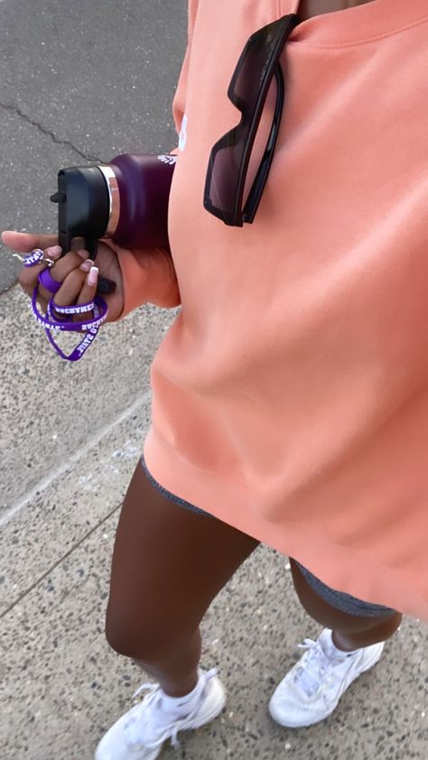 orange sweatshirt, purple water bottle, orange outfit, biker shorts, target, nike tennis shoes, white sneakers Walks Black Woman, Walking Aesthetic Black Woman, Sweats Aesthetic, May Vision Board, Girls Stomach, Walk Outfit, 2024 Background, Baddie Era, Girl Walk