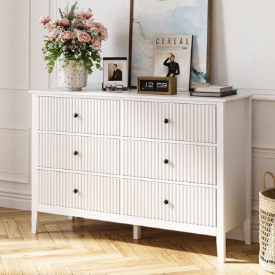 Experience the enchantment with our tailored drawer dresser for young ones. Precision-crafted from premium wood materials, our dresser eliminates overpowering odors, offering a subtle woody scent that brings a touch of nature to your space. Meticulously sealed edges and high-quality drawer slides harmonize in our vanity set, ensuring both flawless functionality and enduring allure. Elevate your living experience with this irresistible blend of style and endurance, making it essential for young d White 6 Drawer Dresser, Double Chest Of Drawers, Dresser Wood, Wide Chest Of Drawers, Modern Chests, Modern Chest Of Drawers, Nursery Dresser, Sideboards Living Room, Wooden Storage Cabinet