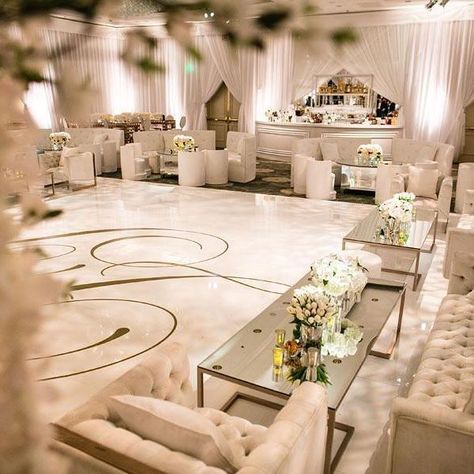 The reception was designed as a modern white lounge. The ballroom was draped with a soft white chiffon and the center covered in a seamless white dance floor with a gorgeous monogram script in gold. Creative partners: Planning and Design" @DetailsAlicia for #aboutdetailsdetails Design and Furnishings: @revelrymatias for @revelryeventdesign and Floral and Design: /eddiezaratsian/ for /tictockflorals/ Photography: /samuel/.black and /alexsmithphoto/ for @samuellippkestudios Lighting: /lonnie_ Wedding Lounge Seating, Beverly Hills Wedding, White Dance, Wedding Reception Lighting, White Weddings Reception, Indoor Wedding Receptions, White Lounge, Wedding Lounge, Lounge Party