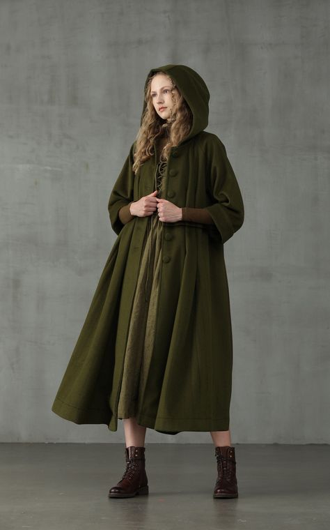 Embrace your sophisticated side with Linennaive Playing with proportions and details, we presents a new take on the classic 100% wool coat for our winter collection.  It is given an unique look with its oversized hood and napping 100% wool in moss green.  With deep side pockets and handmade pintucks all over the coat, it is cut for a mid-length and creates a striking voluminous silhouette.  We are sure this coat will make colder weather your favourite forecast.  Ensure that your outerwear is the Red Apron, Hooded Wool Coat, Cashmere Cape, Cozy Coats, Green Retro, Linen Fashion, Coat Winter, Comfort Wear, Vintage Coat