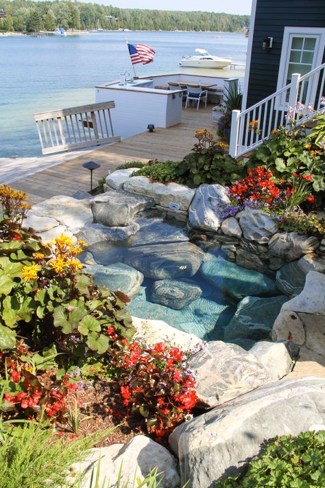 What could be better than sitting in a custom hot tub next to the lake shore? #nature#naturalstone#hottub#custom#lake#upnorth#customspa#spa Natural Rock Hot Tub, Natural Stone Hot Tub, Pool By The Lake, Pool That Looks Like A Lake, Natural Looking Hot Tub, Natural Hot Tub Backyard, In Ground Hot Tub, Stone Hot Tub, Natural Hot Tub