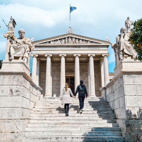 Travel couple posing in front of Academy of Athens, Greece Famous Photos, Walking Routes, Classic Architecture, Love Photo, Acropolis, Rooftop Bar, Booking Hotel, Best Photo, Athens Greece