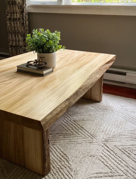 Our Live edge coffee tables are a unique and stylish addition to any home or office space. These tables are crafted from natural wood slabs, typically featuring the natural edge of the tree, which creates a one-of-a-kind look that cannot be replicated. The edges of the table are left raw, allowing the natural texture and character of the wood to shine through. These table and all of our products are made from 100% solid wood slabs, no veneer, particle, compressed, or laminate boards are used.  Each live edge coffee table is handcrafted and therefore, has its own unique features, such as the size, shape, and grain pattern. These tables are available in a range of wood species, such as elm (shown), walnut, spalted maple, and are finished with a several coats of a professional grade lacquer t Natural Wood End Table, Raw Edge Coffee Table, Raw Wood Coffee Table, Coffee Table Live Edge, Slab Coffee Table, Wood Coffee Table Rustic, Pine Coffee Table, Table Live Edge, Live Edge Coffee Table