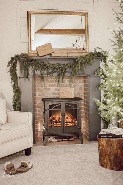 Farmhouse style Christmas bedroom decor, with a beautiful faux brick fireplace, mantel painted in Farrow and Ball Downpipe, real cedar garland, a golden mirror, and so much more.  Such a cozy space full of elegant and effortless Christmas decor! #decoratingyourbedroom Faux Wood Stove Fireplace, Brick Fireplace Mantel, Easter Fireplace Mantel, Faux Brick Fireplace, Fireplace Farmhouse, Faux Mantle, Faux Farmhouse, Scandinavian Farmhouse Style, Space Heater Fireplace