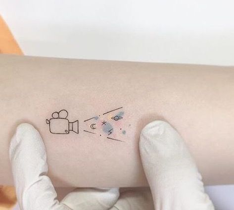 Cute Movie Tattoos, Tiny Movie Tattoos, Movie Ticket Tattoo Ideas, Movie Theater Tattoo, Movie Lover Tattoo Ideas, Cinephile Tattoo, Music Lover Tattoo Simple, Acting Tattoo Ideas, Cinematography Tattoo