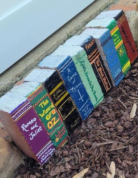 Bricks painted to look like books Paint Bricks To Look Like Books, Diy Brick Books, Bricks Painted As Books, Painting Bricks For Garden, Painted Bricks To Look Like Books, Book Bricks Diy, Garden Brick Books, Painted Garden Bricks, Painted Brick Books