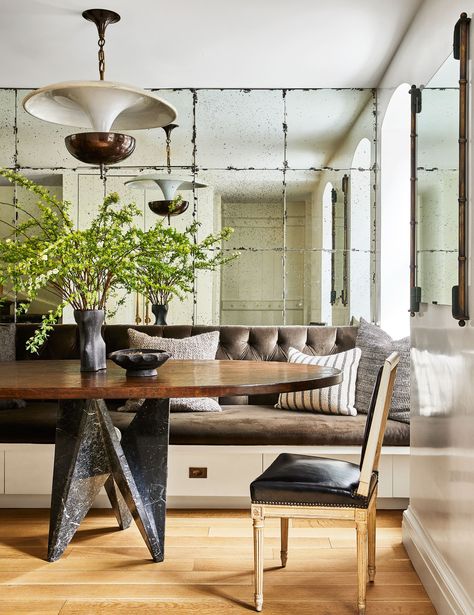 Custom mirrors by TG Glass works line a wall in the dining area where the table has a 1980's Italian base and a custom... Nate And Jeremiah, Jeremiah Brent, New York Homes, Nate Berkus, Mirror On The Wall, Banquette Seating, Dining Nook, Decoration Inspiration, A Living Room