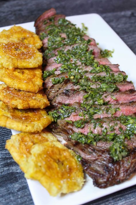 Using a cast iron grill pan, you can create a perfectly Grilled Flank Steak from the comfort of your home kitchen. Topped with Chimichurri Sauce and served with Fried Plantain/Tostones, this recipe is sure to have your guests begging for more. #thedailyspeshyl #grilledflanksteak #tostones #steakdinner | thedailyspeshyl.com Plantain Tostones, Grilled Plantains, Steakhouse Recipes, Fried Plantain, Gourmet Grilling, Flank Steak Recipes, Cast Iron Grill Pan, Iron Grill, Grilled Flank Steak