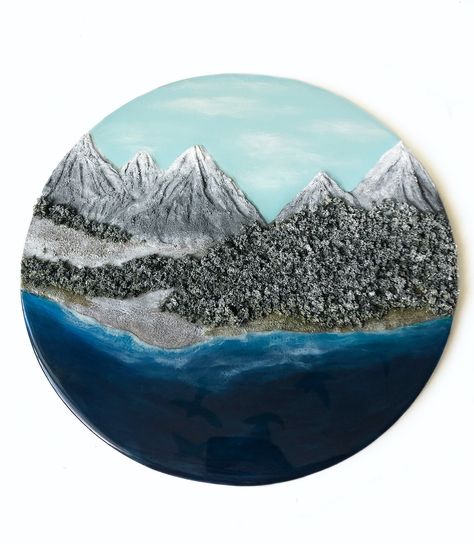 New series from Fire Water Fluid! I love mountains just as much as I love the water. I've climbed a few mountains, not physically and figuratively and so focusing on creating pieces that speak to that, felt appropriate moving into the new year.  This is the first piece in the series. It's a 14” plywood round with clay and resin making up the bulk of it.   #resinart #artresin #landscapeart #resin #clay #mountains #water #ocean #coastline #wallart Resin Mountain, Winter In The Mountains, Love Mountains, Resin Making, Clay And Resin, Water Ocean, Fire Water, Resin Clay, Resin Painting