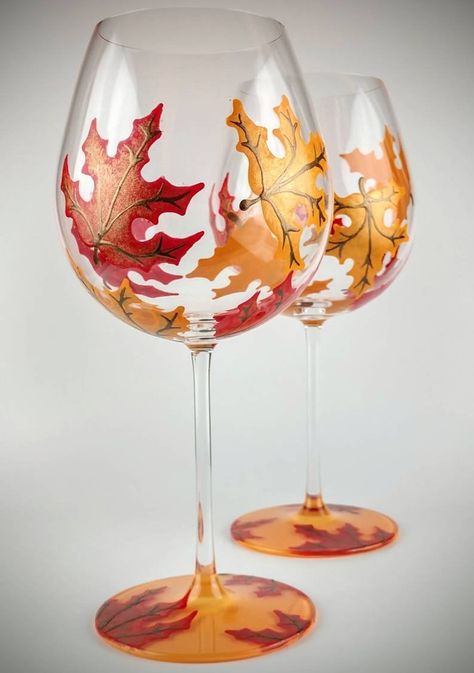 2 Colorful, fall leaf stemmed hand painted wine glasses. Maple leaves in colors of orange and red surround each glass. The base is painted orange on the bottom side, with a few leaves on the top of the base. Each leaf has veins and stems painted in warm, metallic brown.  The glasses are really nice Wine Glass Designs, Hand Painted Wine Bottles, Decorated Wine Glasses, Hand Painted Glassware, Hand Painted Glasses, Glass Painting Designs, Wine Glass Crafts, Stained Glass Paint, Plates Diy