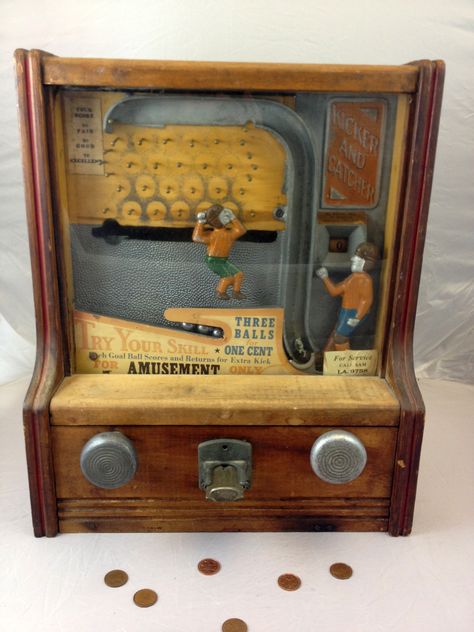 Fabulous 1930s Coin-Operated Penny Arcade Kicker and Catcher Football Game    Behind the glass front panel, a colorful metal kicker and catcher, clad in vintage 1930s football attire are just waiting for the penny to drop. A penny releases three metal balls to the kicker, who then punts them one by one in the direction of the catcher. Before reaching the catcher, each ball must travel through a maze of metal pegs. Slot Machine Tattoo, Curiosities And Oddities, Game Cabinet, Coin Op Machine, Vintage Slot Machines, Diy Video Game, Vintage Arcade, Arcade Game Machines, Penny Arcade