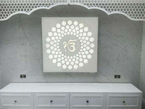 Ek Onkar symbol illuminated for prayer room. Designed for new home in UK. White corian and perspex White Mandir For Home, White Mandir Design Puja Room, Puja Room Design Indian Modern, Puja Room Design Indian, White Pooja Mandir, Ek Onkar Symbol, Corian Mandir Design With Door, Onkar Symbol, Acrylic Om Design For Mandir