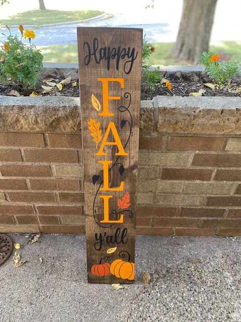 "Hand-painted Wood Sign \"Happy Fall Y'all\" Stained in dark walnut.  Colored vines, pumpkins, and leaves in different fall colors.  Looks so fally and crisp! Love the vertical signs!  Decorate for fall in any part of your house.  These signs fit in anywhere. Display now through Thanksgiving.  Great for Halloween and Thanksgiving.  Front doors and entryways are awesome for these! So popular on patios, patios, decks, steps, etc. measures 36\" tall x 7.5\" wide Everything is stained and painted. Patio Deck Decor, Vertical Signs, Pumpkins And Leaves, Halloween Porch Sign, 2x4 Projects, Fall Wood Crafts, Decorate For Fall, Welcome Signs Front Door, Deck Decor