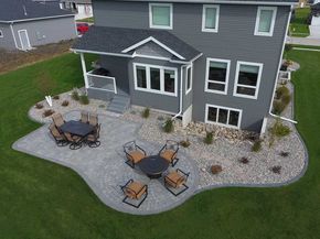 This landscaping project really adds to the appeal of this backyard. It looks like it was built with the house! The similar colors of the patio pavers and the exterior of this house is not something you get with every landscape. It really makes this patio jump out of the space. The combination of Patio Edging, Paver Designs, Concrete Patio Designs, Patio Pavers Design, Concrete Patios, Restaurant Patio, Patio Landscaping, Small Backyard Patio, Paver Patio