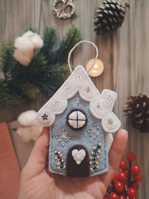 Christmas Cottage  Felt cottage/house, complete with small door and window. I embroidered some branches, snowflakes and added silver stars and beads to give it a sparkling touch. Every detail is designed and sewn by hand with such care. Hang on branches, walls or doors. Slowly with the seasons. ❄ I created this little decoration for those who love winter, snow and the forest. 🤍 Winter Felt Crafts, Hand Sewn Christmas Decorations, Christmas Decorations Hanging, Felt Stuffies, Felt Snowflakes, Felt Beaded Ornaments, Christmas Decorations Felt, Hand Sewn Ornaments, Felted Christmas Decorations